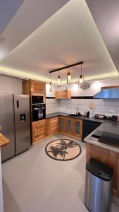 a large kitchen with a refrigerator and a counter at DUPLEX 101 in Dzaoudzi