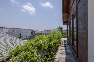 a view from the balcony of a house with plants at Canggu Spirit Guest House in Canggu +45 photos