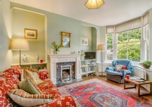 a living room with a couch and a fireplace at 3 St Mary's Villas in Hay-on-Wye