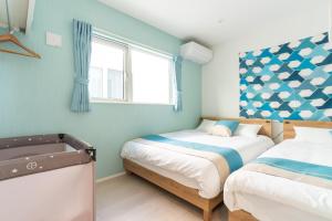 Voodi või voodid majutusasutuse グランディオーソ沖縄プールヴィラ金武2 toas +223 fotot