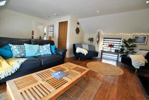 a living room with a couch and a coffee table at Net Loft- homely accomodation in East Neuk in Anstruther