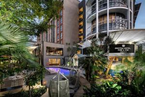 a building with a pool in front of it at Protea Hotel Fire & Ice! by Marriott Durban Umhlanga Ridge in Durban