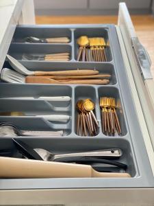 a drawer full of utensils in a container with at فيلا بمسبح وحديقة خاصة in AlUla