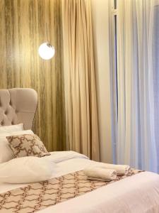 Schlafzimmer mit einem Bett und einem Fenster mit Vorhängen in der Unterkunft فيلا بمسبح وحديقة خاصة in Al-'Ula