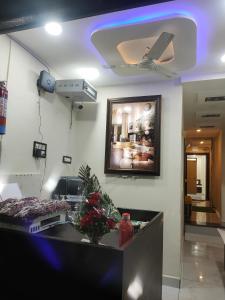 a room with a ceiling fan and a living room at Hotel villa in Ujjain