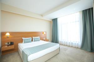a bedroom with a large bed and a large window at Khazar Inji Hotel in Baku +65 photos
