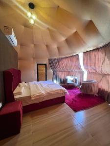 a bedroom with a bed in a room with a wooden ceiling at Wadi Rum Mars Camp in Wadi Rum