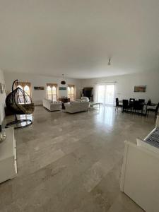 a large living room with couches and a table at Jabal Sifah Tha Marina View Apartment in Muscat