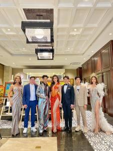 a group of people posing for a picture in a hotel lobby at The Odys Boutique Hotel in Ho Chi Minh City