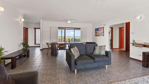 a living room with a couch and a table at Casa De Praia Coffin Bay in Coffin Bay