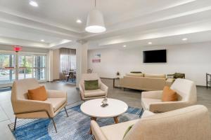 a waiting room with couches and a tv at Fairfield Inn & Suites - Boone in Boone