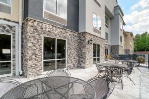 a patio with tables and chairs in front of a building at Fairfield Inn & Suites - Boone in Boone