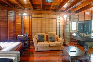 ein Wohnzimmer mit einem Sofa und einem Tisch in der Unterkunft Kaengkrachan Boathouse Paradise Resort in Kaeng Kachan