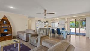 a living room with a couch and a table at Mariners View Coffin Bay in Coffin Bay