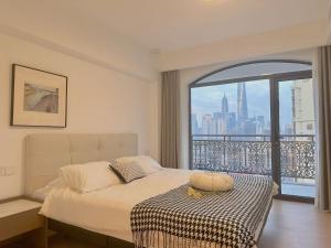 a bedroom with a bed and a large window at Sun Garden - Near the Bund in Shanghai