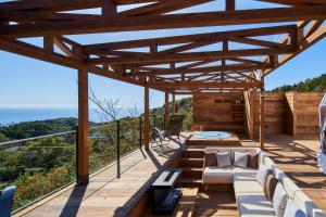 a wooden patio with a view of the ocean at Glamping Resort GLANSO NAGASAKI in Nagasaki