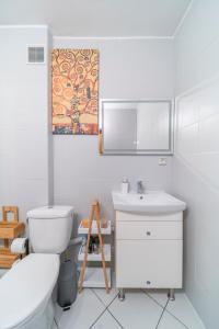 W łazience znajduje się toaleta, umywalka i lustro. w obiekcie Apartament Fossa w Warszawie