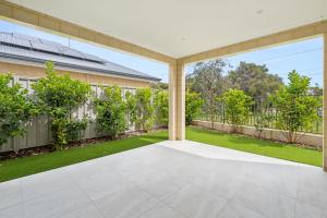 an empty patio in a house with a garden at Modern Minimalistic Home in Perth