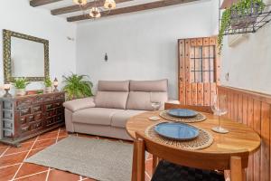 a living room with a table and a couch at Casita Frigiliana in Frigiliana