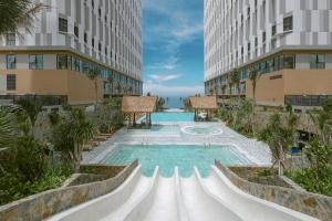 a swimming pool in the middle of a building at Mandala Cham Bay Mui Ne in Phan Thiet +45 photos
