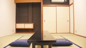 a gym with a bench in the middle of a room at 4S STAY Awaikeda Ekimae in Miyoshi