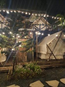 a large tent is lit up at night at Ma Lá Glamping Đà Lạt in Da Lat