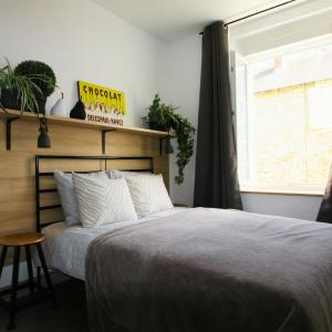 a bedroom with a bed and a window at Maison Tarrade in Châteauneuf-la-Forêt +6 photos