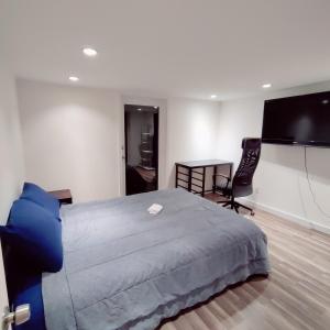 a bedroom with a large bed and a flat screen tv at Fancy SF Suite, Prime Location, Near Fishermans Wharf, SF Bay and Financial District in San Francisco