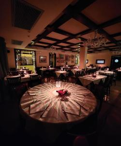 a dining room with a table with flowers on it at Hotel Mistrello in Borgo Val di Taro