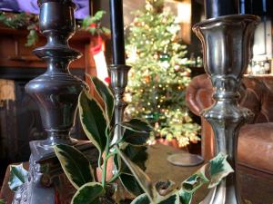 two vases sitting on a table with a christmas tree at 23 Mayfield in Edinburgh