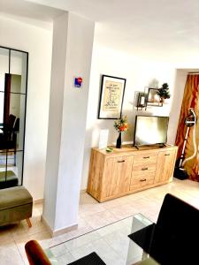 a living room with a television on a wooden dresser at Apartment La Esquina in Denia