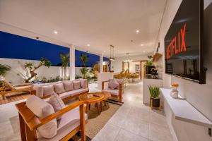 a living room with a couch and a table at *NEW* Modern 3BD Villa in quiet Perenenan! in Canggu