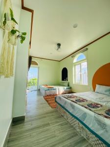 um quarto com 2 camas e uma janela em Gió Homestay and Coffee em Ấp Khánh Phước (1)