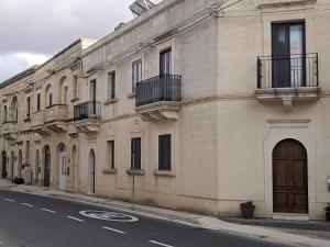 a building on the side of a street at Ta' Stef's Holiday Suites in San Lawrenz