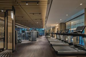 a gym with a row of treadmills at Four Seasons Hotel Suzhou in Suzhou
