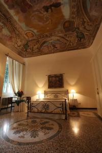 1 dormitorio con 1 cama y una pintura en el techo en Cà del Vescovo, en Imperia