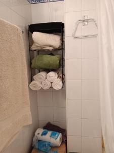 a bathroom with a towel rack with towels at Casa Pepa in Bubión
