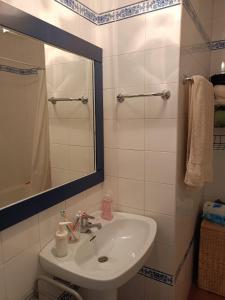 a bathroom with a sink and a mirror at Casa Pepa in Bubión
