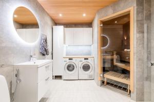 a white laundry room with a washer and dryer at Valoisa rivitalokolmio in Rovaniemi