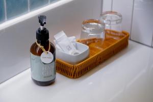 a bottle of wine and a basket on a bathroom counter at Buri Sriphu Hotel & Convention Centre in Hat Yai