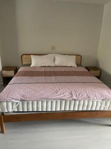 a bedroom with a bed with a pink blanket at Phuket Palace Condumminium in Patong Beach