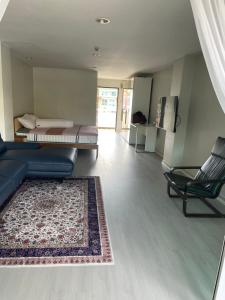 a living room with a couch and a bed and a rug at Phuket Palace Condumminium in Patong Beach