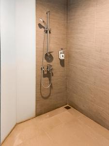 a bathroom with a shower with a shower head at Guide Education Culture Hotel Kaohsiung Museum of Fine Arts in Kaohsiung