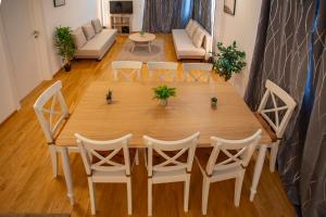 a wooden table and chairs in a living room at NEW East Side Apartment Innsbruck I Free Parking in Innsbruck