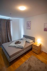 a bedroom with a bed with a nightstand and a bed sidx sidx sidx sidx at Innsbruck East Side Apartment I Free Street Parking in Innsbruck
