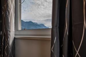 a window with a view of a mountain at NEW East Side Apartment Innsbruck I Free Parking in Innsbruck