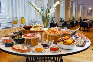 a table filled with lots of different types of food at Boutique Hotel Museum Belgrade in Belgrade