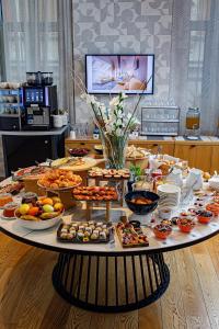 a table with many different types of food on it at Boutique Hotel Museum Belgrade in Belgrade