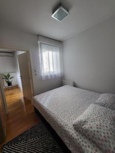 a bedroom with a bed and a window at Apartment Tonci Vrbani in Zagreb