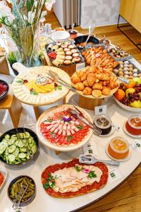 a table with many different types of food on it at Boutique Hotel Museum Belgrade in Belgrade